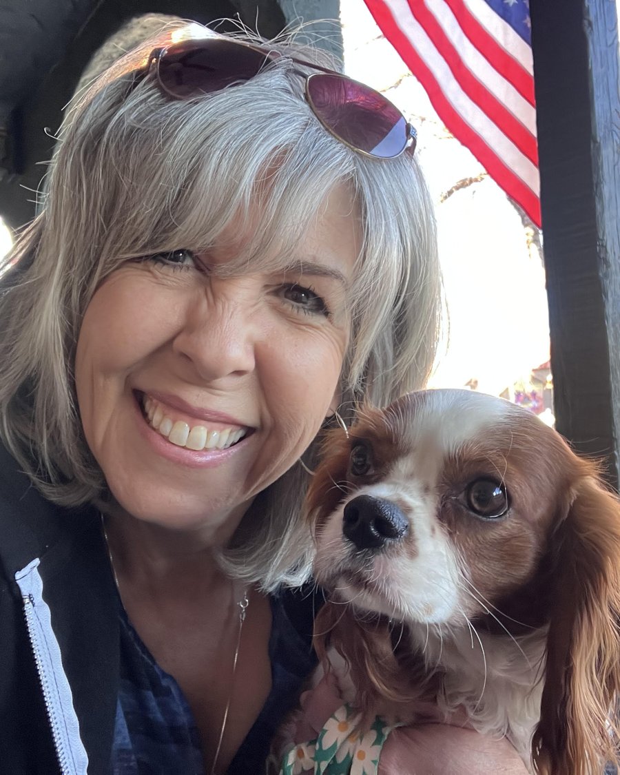 Michele Bastone outdoors, smiling, with a dog.