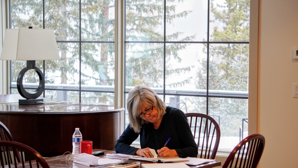 Michele Bastone working thoughtfully by a window.